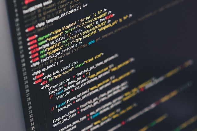 Developer working at a laptop with code on screen
