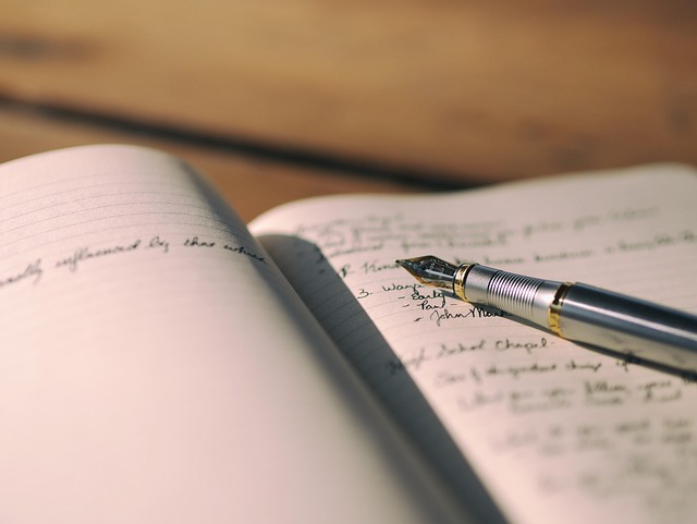 Pen and notebook ready for writing a check