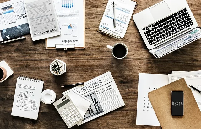 Personal finance planning at a desk with documents and a laptop